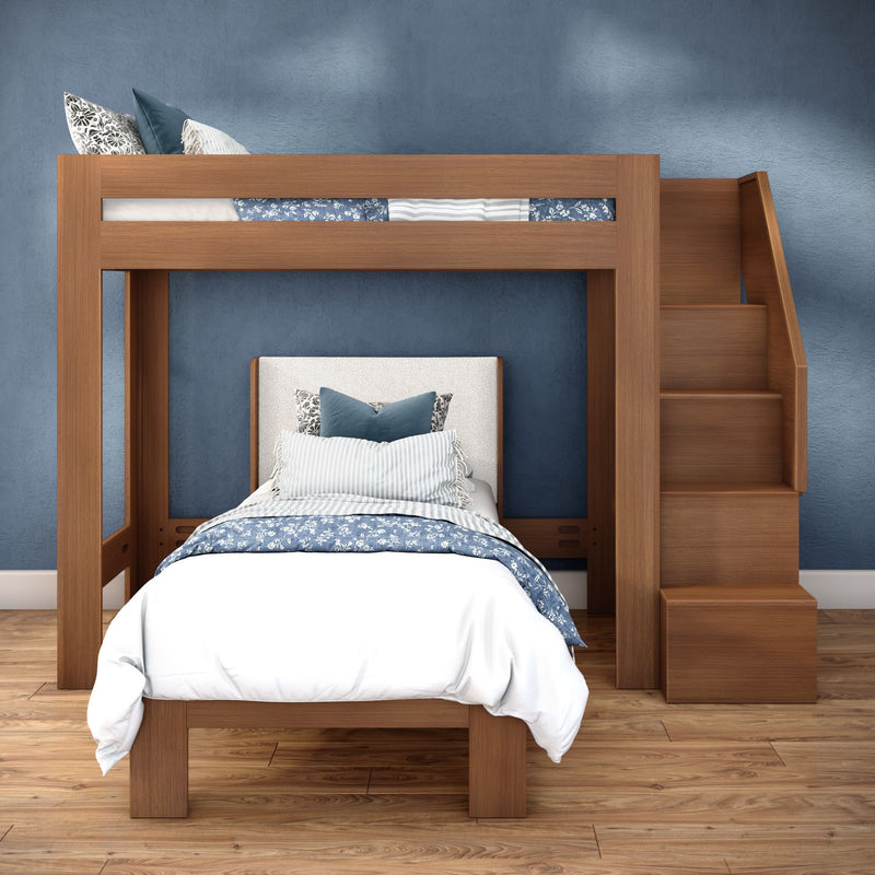Modern wooden loft bunk bed with built-in stairs, blue patterned bedding and white linens in a space-saving kids' bedroom with hardwood floor