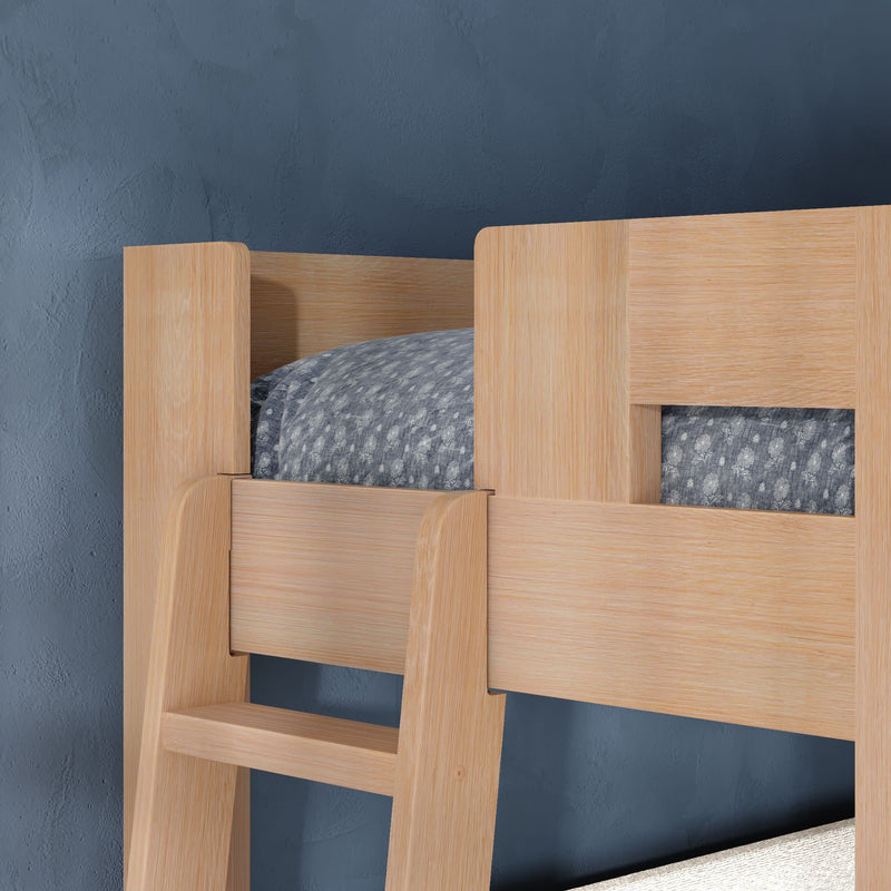Close-up of light oak wooden bunk bed ladder and guardrail with gray patterned bedding against a navy blue textured wall