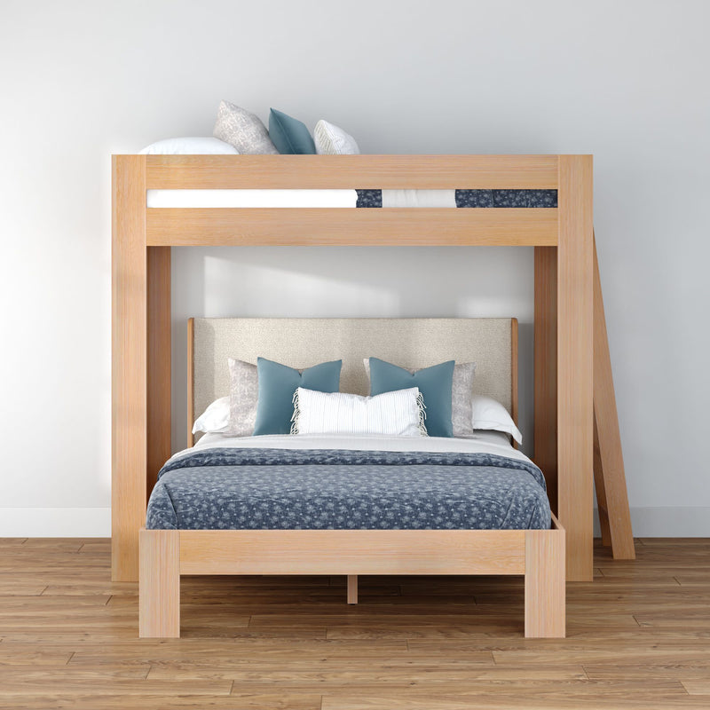 Modern light-wood space-saving bunk bed with queen-size lower bed, upholstered headboard, blue patterned bedding and decorative pillows in a minimalist bedroom with hardwood floor