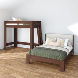 Modern minimalist bedroom with dark wood loft bed and matching wooden platform bed, green quilted comforter, beige decorative pillows and ladder on light hardwood floor