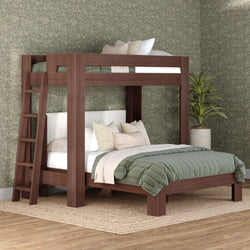 Solid walnut-finish wooden bunk bed with ladder, green quilted bedding and neutral pillows in a modern bedroom with patterned wallpaper and potted plant