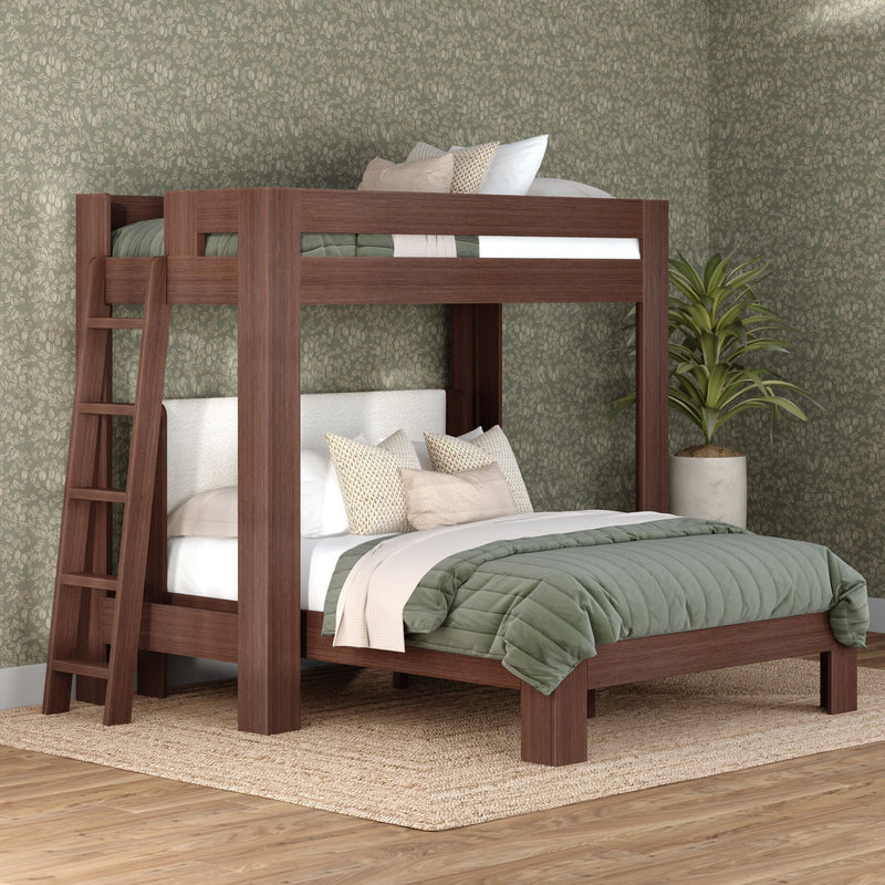 Solid walnut-finish wooden bunk bed with ladder, green quilted bedding and neutral pillows in a modern bedroom with patterned wallpaper and potted plant