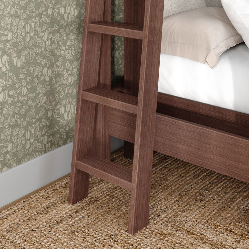 Wooden bunk bed ladder and frame in walnut finish beside green floral wallpaper, beige linen bedding and natural jute rug — modern rustic bedroom decor