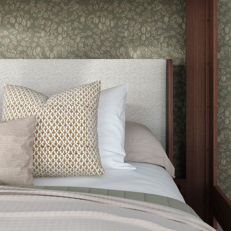 Beige upholstered headboard, green floral wallpaper, gold-patterned pillow and neutral bedding in modern bedroom