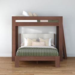 Modern walnut wood bunk bed with full-size lower bed and twin loft upper bunk, green quilt and beige accent pillows in minimalist bedroom