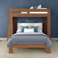 Modern wooden bunk bed with full-size lower bed and twin top bunk, gray-blue patterned comforter, teal accent pillows, upholstered headboard and navy blue textured wall in a contemporary bedroom interior