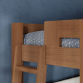 Modern natural wood bunk bed with integrated ladder and gray patterned bedding against a blue textured wall — children's bedroom furniture