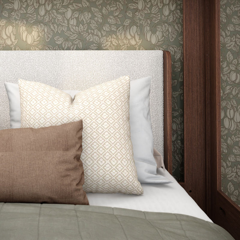 Cozy modern bedroom close-up: upholstered boucle headboard with patterned beige and brown decorative pillows, sage quilt, floral wallpaper