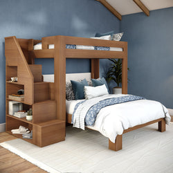 Modern wooden bunk bed with built-in staircase and cubby storage in blue bedroom, full-over-twin loft bed with white and blue patterned bedding, rug and potted plant