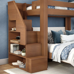 Modern wooden bunk bed with staircase and built-in storage shelves, blue patterned bedding and decorative pillows in a cozy kids' bedroom
