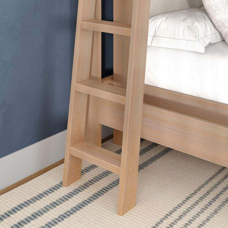 Close-up of light wood bunk bed ladder attached to a platform bed in a modern bedroom with a blue textured wall and striped area rug