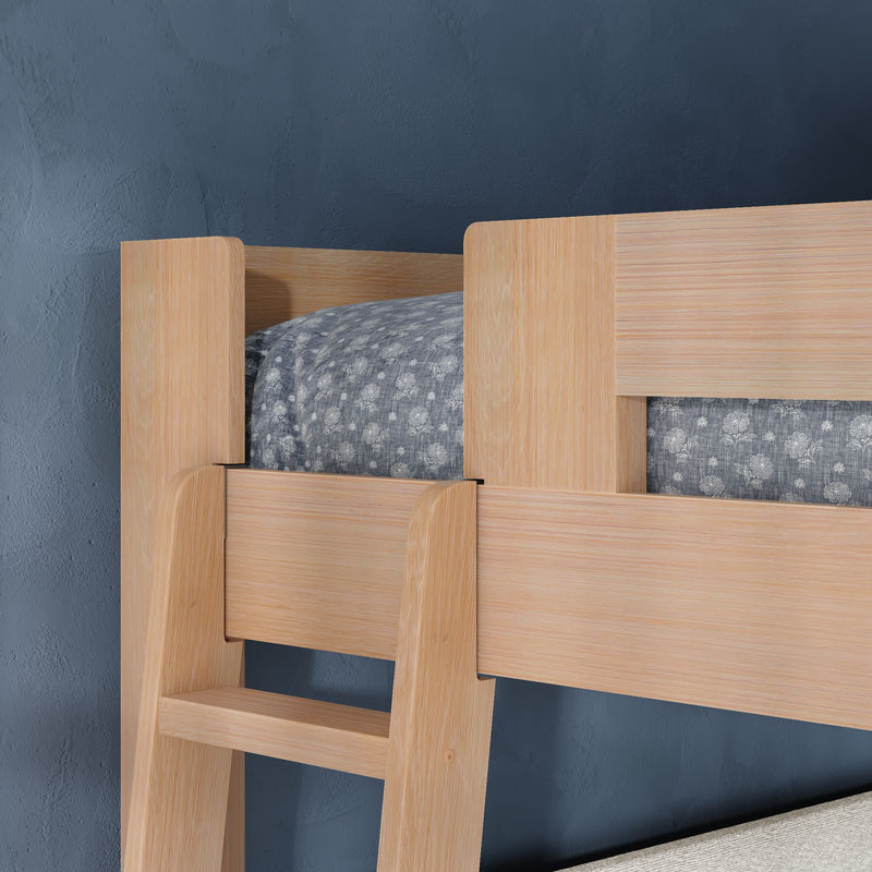 Close-up of natural wood bunk bed ladder and guardrail with gray floral bedding against a navy blue bedroom wall