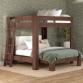 Space-saving modern walnut bunk bed with ladder, lower full bed, green quilted bedding, decorative pillows, floral wallpaper and jute rug