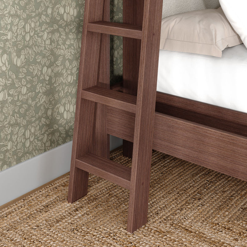 Close-up of walnut wood bunk bed ladder and frame beside green floral wallpaper, beige bedding and woven jute rug