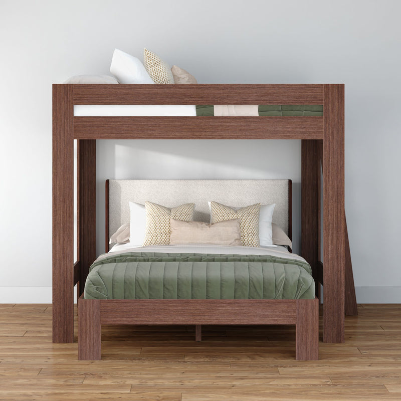 Modern wooden loft bunk bed with queen-size lower bed and twin upper bunk, green quilted comforter and beige decorative pillows on hardwood floor