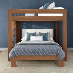 Contemporary wooden bunk bed with full-size lower bed and twin upper bunk, gray-blue patterned bedding, teal accent pillows, upholstered headboard, navy textured wall and beige geometric rug