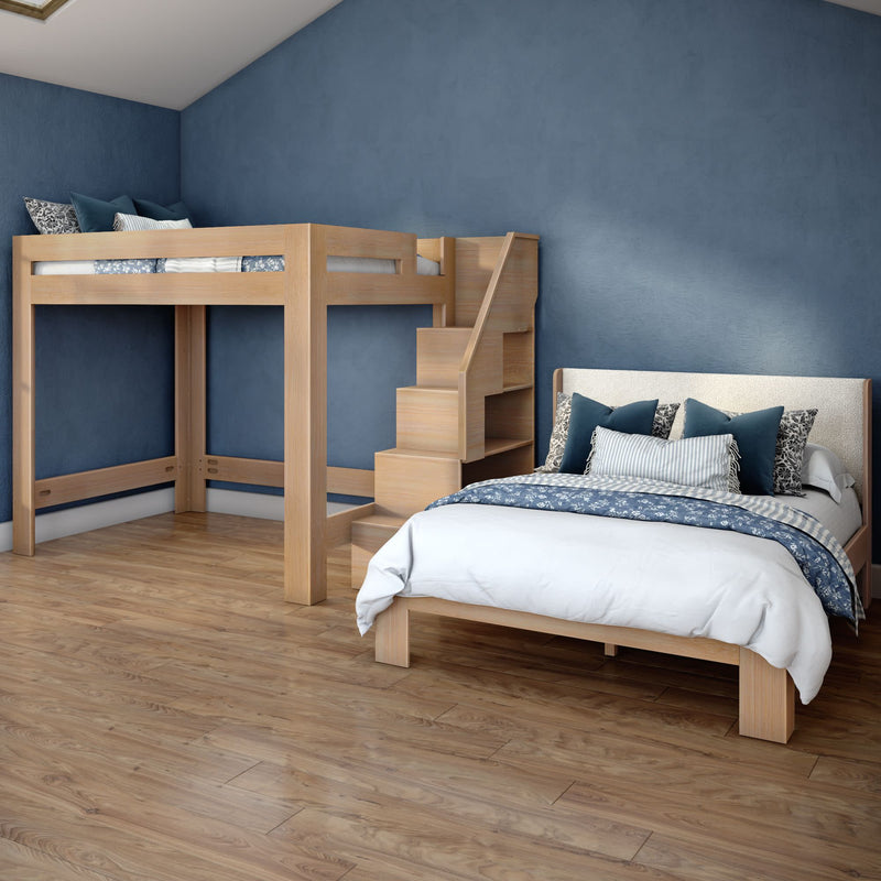 Modern kids' bedroom with wooden loft bed and full-size bed, built-in staircase storage, navy and white bedding, blue accent wall and hardwood floor