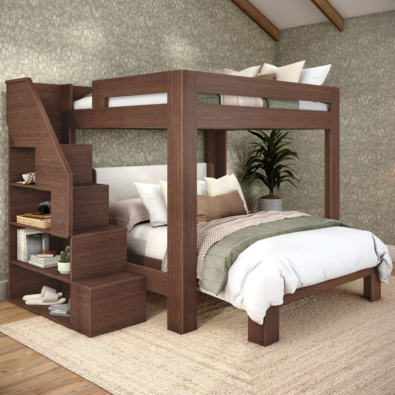 Wooden loft bunk bed with built-in staircase storage, full-size lower bed, green quilt and neutral pillows in a cozy contemporary bedroom with floral wallpaper and potted plant