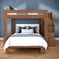 Modern wooden bunk bed with full lower bed and twin loft, built-in stairs, blue floral bedding on hardwood floor in stylish bedroom