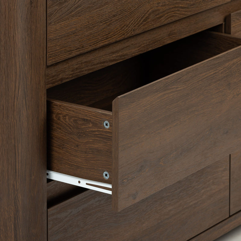 Close-up of an open dark brown wood dresser drawer with visible wood grain and metal drawer slides, modern rustic bedroom storage detail