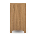 Side view of tall oak-finish wooden cabinet with natural wood grain and rounded cutout base, modern narrow storage dresser