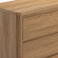 Close-up of modern oak dresser drawers showcasing natural wood grain and light oak finish