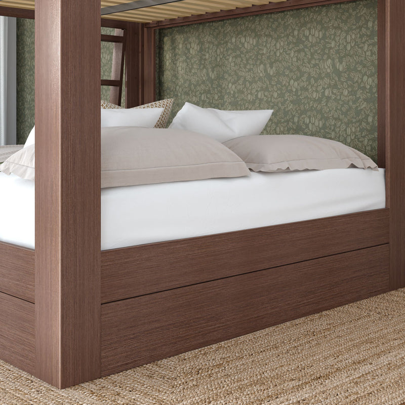 Modern walnut four-poster platform bed with built-in storage base, white mattress and beige pillows against a green floral wallpaper accent wall over a jute rug