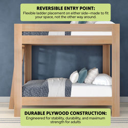 Modern natural wood bunk bed (twin over twin) with reversible ladder, durable plywood construction for adult strength, space-saving loft design styled with blue-gray bedding and pillows against a navy wall