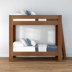 Modern wooden twin-over-twin bunk bed with blue and white bedding, decorative pillows and ladder on hardwood floor in minimalist bedroom