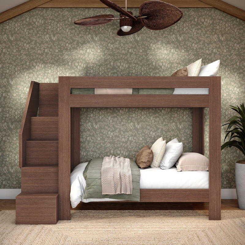 Walnut wooden bunk bed with staircase storage, twin-over-full, green floral wallpaper, cozy neutral bedding and rattan fan