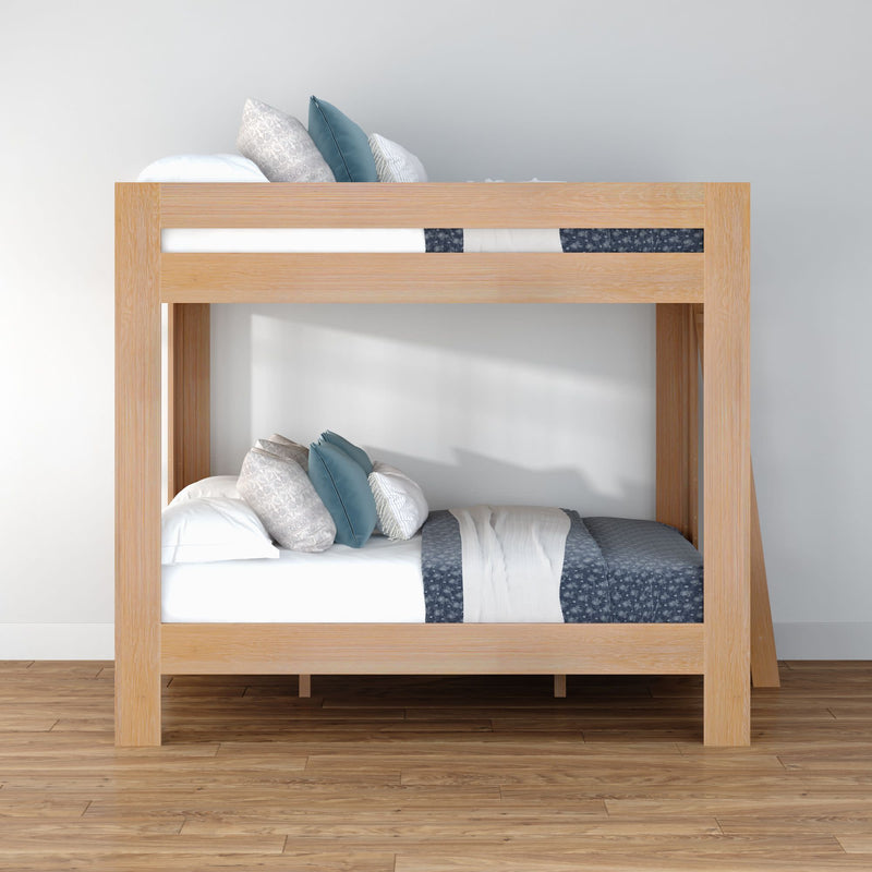 Modern light oak twin-over-twin bunk bed with blue and white bedding and decorative pillows in a minimalist bedroom on hardwood flooring
