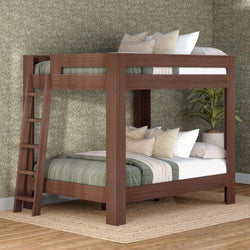 Walnut-finish solid wood bunk bed with built-in ladder, sage green quilted bedding and neutral pillows in a modern farmhouse bedroom with floral wallpaper, jute rug and potted plant