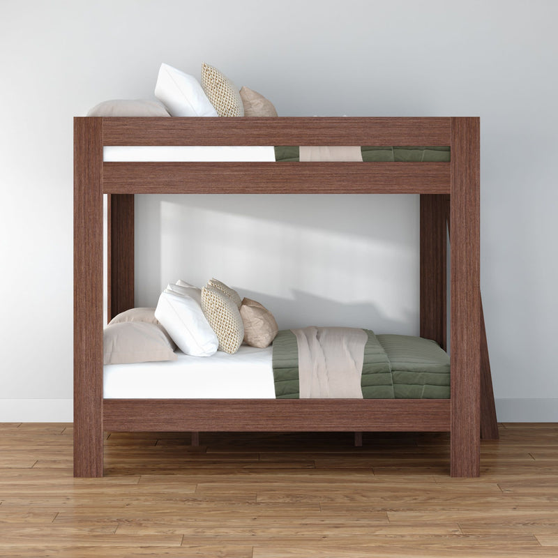 Modern solid wood twin bunk bed with green quilted bedding, neutral throw pillows and hardwood floor in minimalist bedroom