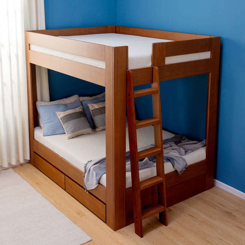 Solid wood bunk bed with ladder and built-in under-bed storage drawers, neutral bedding with blue-gray pillows, set against a blue wall and hardwood floor, modern space-saving bedroom solution