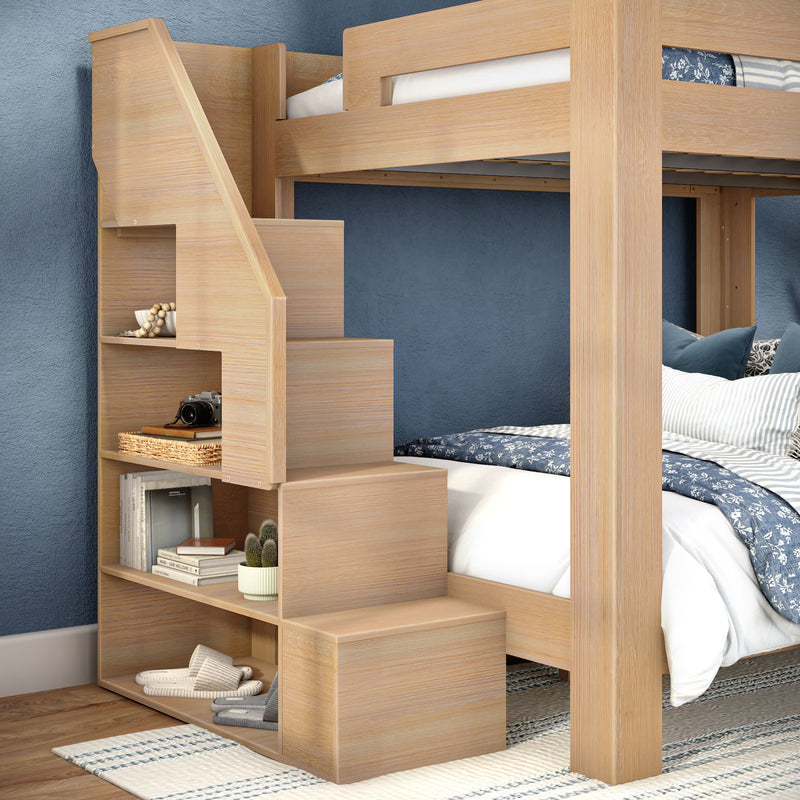 Light wood bunk bed with integrated storage stairs and built-in shelves in a blue bedroom — space-saving kids' bedroom furniture
