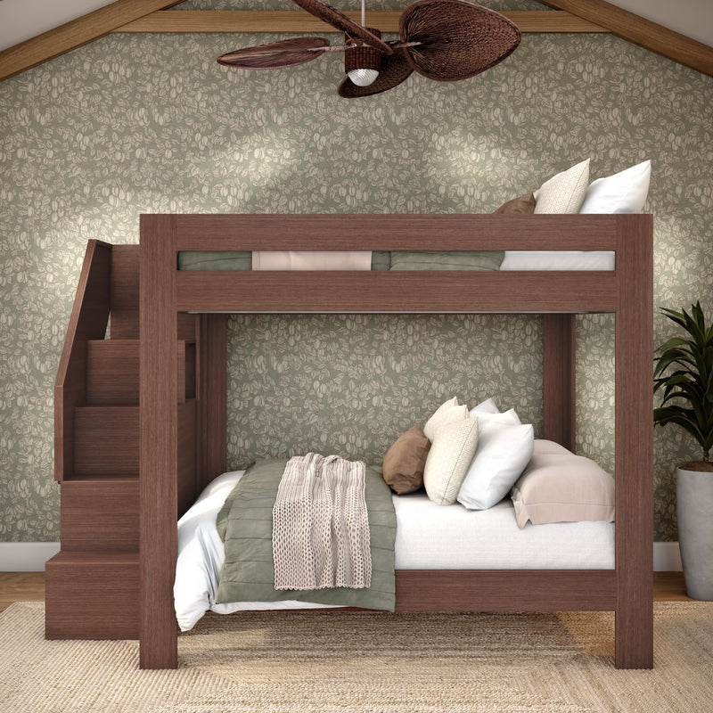 Modern wooden bunk bed with built-in staircase, green floral wallpaper, layered neutral bedding and pillows, wicker ceiling fan and potted plant in cozy bedroom