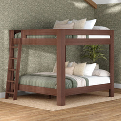 Walnut solid-wood twin-over-full bunk bed with ladder, green quilted bedding, neutral throw pillows, floral wallpaper and jute rug in modern bedroom