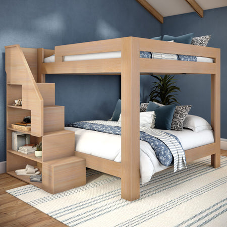 Light-wood loft bunk bed with built-in staircase and storage shelves, blue patterned bedding and textured navy accent wall in a modern bedroom