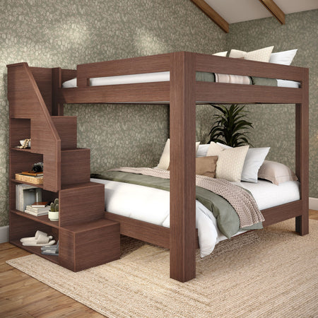 Wooden bunk bed with built-in staircase and open shelving, cozy bedroom with green floral wallpaper, neutral bedding, jute rug and indoor plant