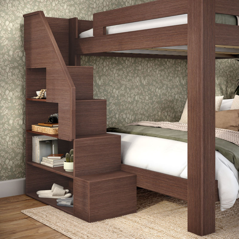 Space-saving walnut wooden bunk bed with built-in storage staircase, cozy lower bed with green bedding and floral wallpaper