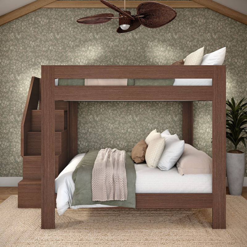 Modern walnut-stained wooden bunk bed with built-in staircase, layered neutral bedding and knit throw, floral wallpaper accent wall, jute rug and potted plant in cozy rustic bedroom