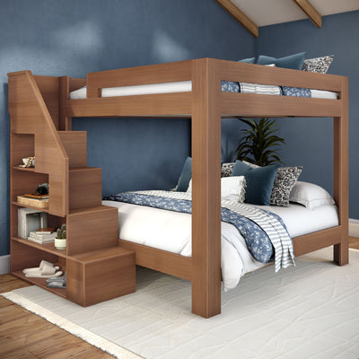 Wooden bunk bed with built-in storage staircase in a modern blue bedroom, featuring blue floral bedding, decorative pillows and space-saving loft bed design for kids and guest rooms