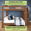 Modern wooden twin-over-full bunk bed with built-in staircase on the right, reversible entry point and durable plywood construction for adult strength, styled with blue floral and striped bedding and decorative pillows against a textured blue wall on hardwood floors