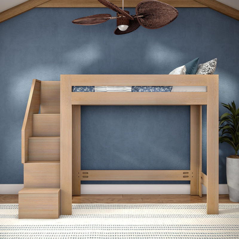 Space-saving natural wood loft bed with built-in staircase and storage, styled in a kids' bedroom with blue accent wall, patterned pillows and striped rug