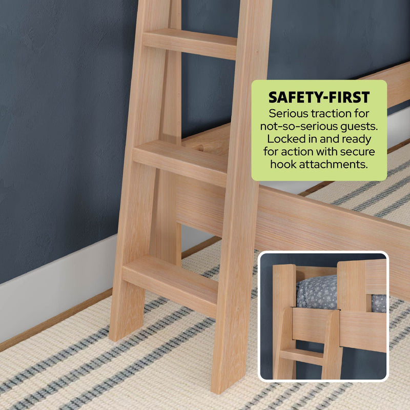 Close-up of natural wood bunk bed ladder with wide treads and secure hook attachments highlighting safety-first traction against a navy bedroom wall and striped rug