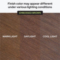 Embossed brown wood finish sample showing color variation under warm light, daylight, and cool light