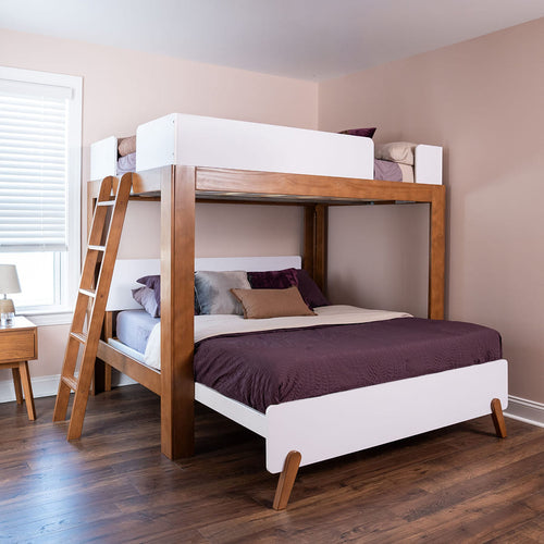 Wooden loft bunk bed with ladder and white guardrails in a modern kids' bedroom with purple bedding, hardwood floors, and window blinds.