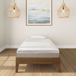 Single bed with modern mattress in minimalist bedroom featuring wooden floor and artistic wall art.