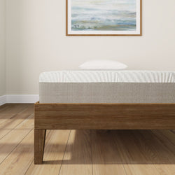 Stylish modern bedroom with wooden bed frame and comfortable mattress in bright minimalist setting.