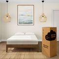 Modern bedroom with a comfortable 10-inch cooling comfort mattress in a minimalist design, featuring elegant pendant lights and a landscape painting above the bed.